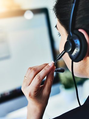 Rearview shot of a young woman working in a call centre