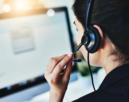 Rearview shot of a young woman working in a call centre